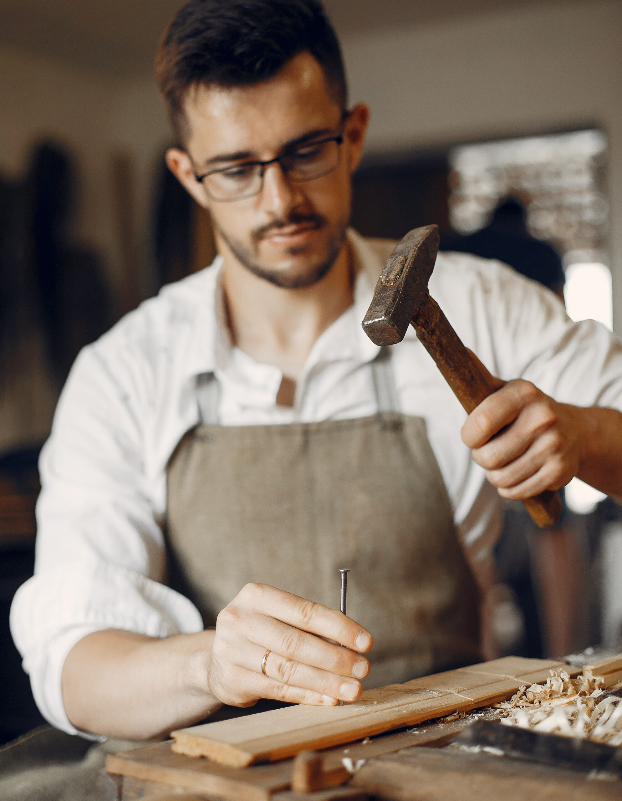 Handsome carpenter working with a wood